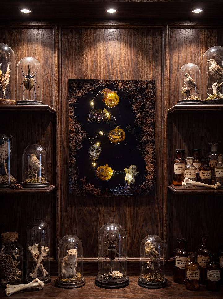 The Midnight Portal illuminated Halloween panel displayed between dark wooden shelves